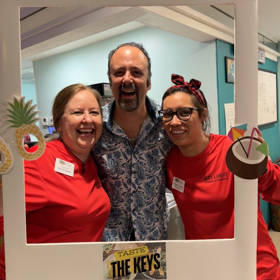 Three guests laughing inside a Taste the Keys photo frame