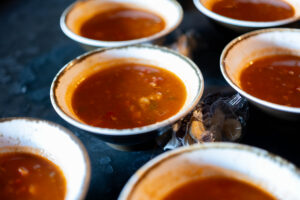 Rows of small bowls of tomato bisque