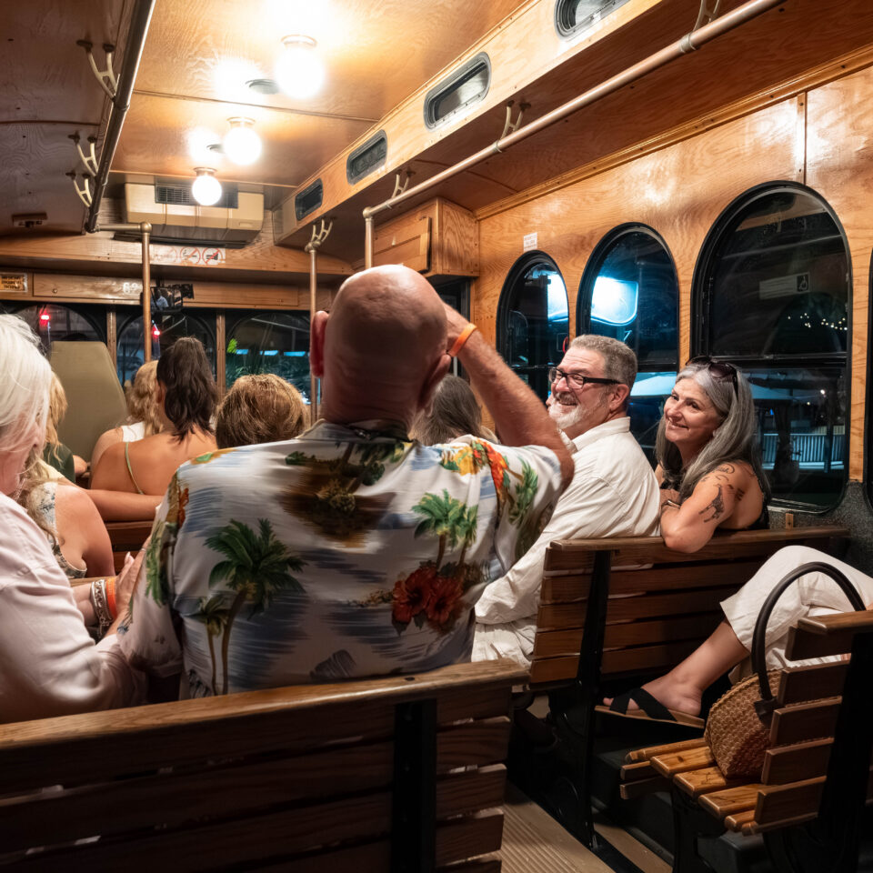 Guests seated inside the wood-paneled trolley during the tour