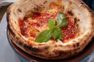 Wood-fired pizza topped with fresh basil